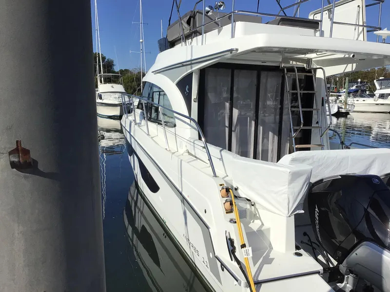 Slide: The Image of 2024 Beneteau Antares 11 Fly yacht docked in marina, side view. - 4