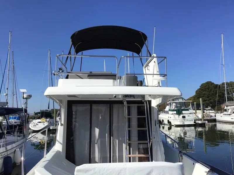 Slide: The Image of 2024 Beneteau Antares 11 Fly yacht docked in marina, rear view. - 5