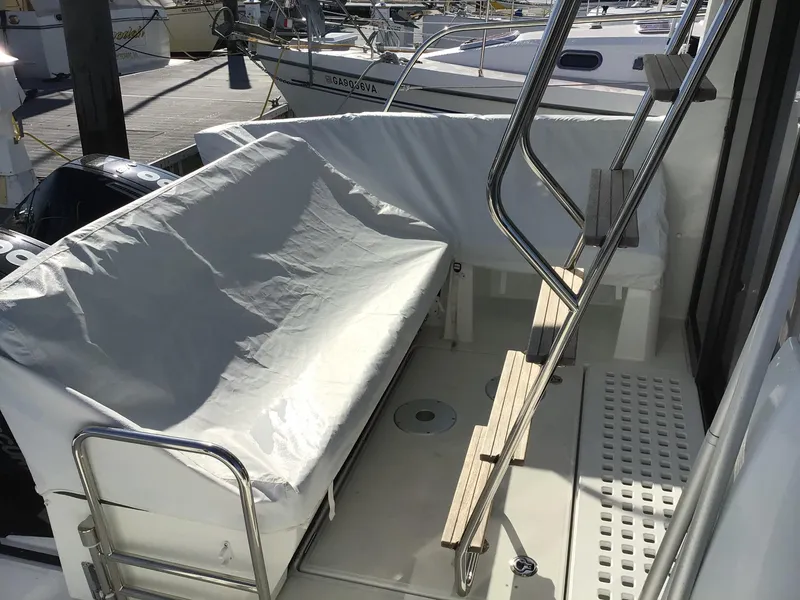 Slide: The Image of 2024 Beneteau Antares 11 Fly deck with covered seating and ladder. - 6