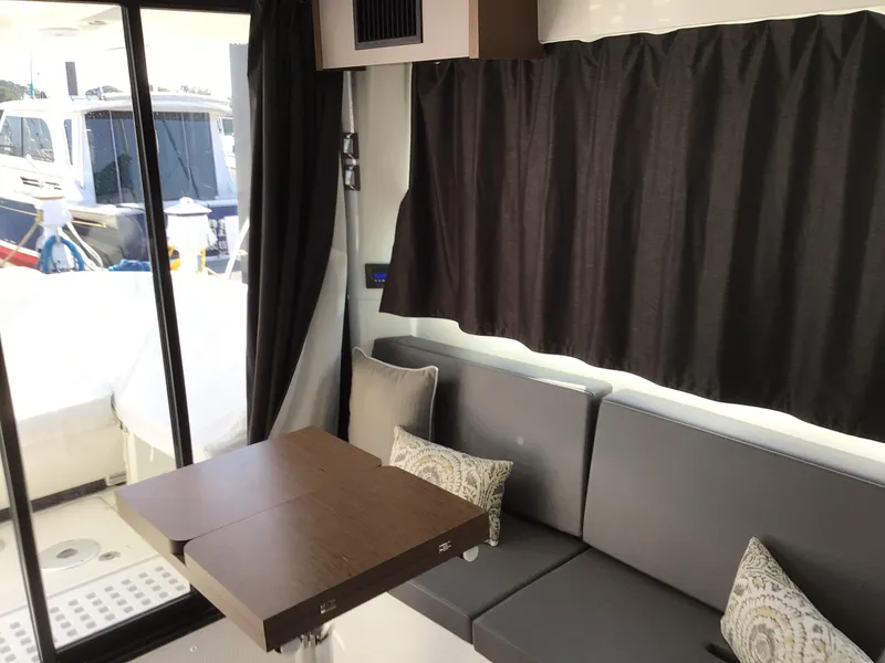 Slide: The Image of Interior of 2024 Beneteau Antares 11 Fly with seating and table, featuring modern design. - 9