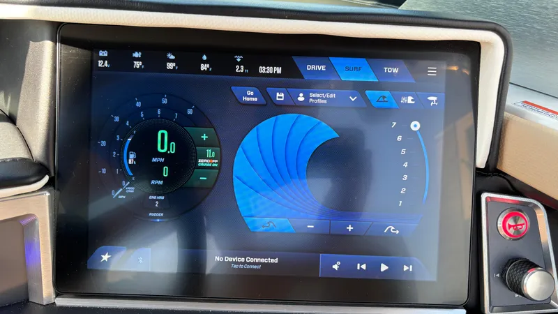 Slide: The Image of 2025 MasterCraft XT24 dashboard display with digital controls and navigation interface. - 24