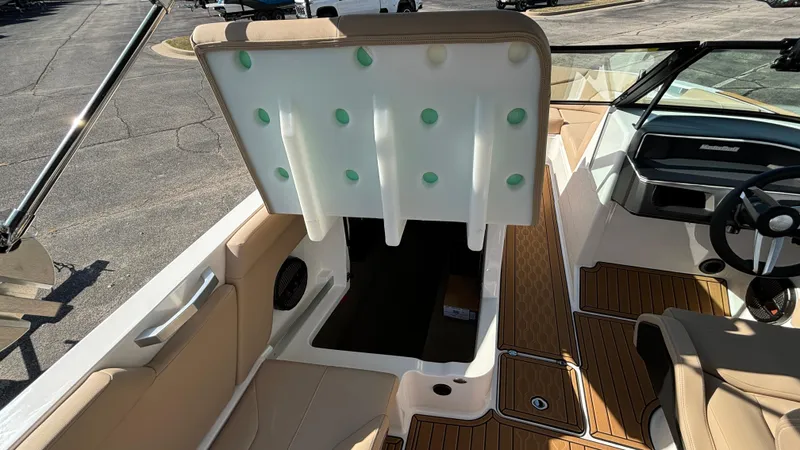 Slide: The Image of 2025 MasterCraft XT24 boat interior with open storage compartment. - 30