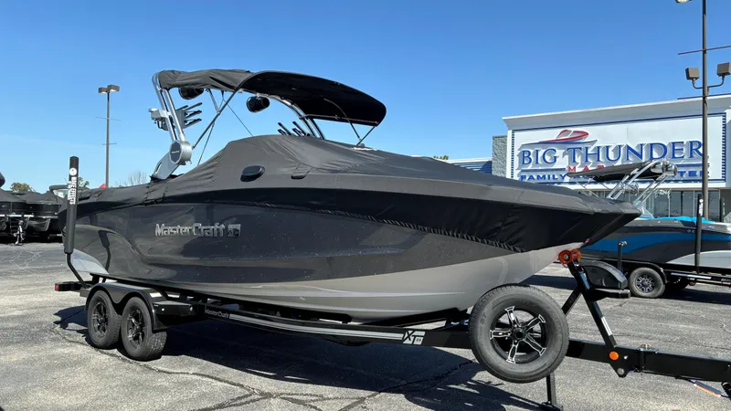 Slide: The Image of 2025 MasterCraft XT24 boat on trailer at dealership. - 39