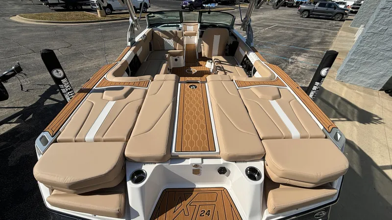 Slide: The Image of 2025 MasterCraft XT24 boat interior with tan seating and wood accents. - 4