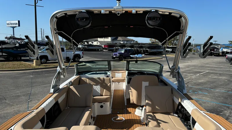 Slide: The Image of 2025 MasterCraft XT24 boat interior with beige seating and modern design. - 7