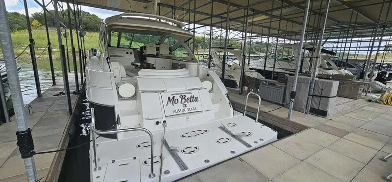 The Image of 2011 Cruisers Yachts 540 docked in a marina, rear view. - 0