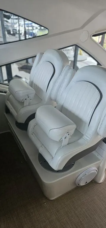 Slide: The Image of Luxury seating in 2011 Cruisers Yachts 540, featuring plush white leather captain chairs. - 10