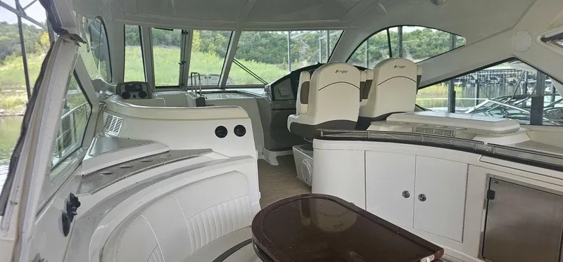 Slide: The Image of Interior of 2011 Cruisers Yachts 540, featuring helm and seating area. - 14