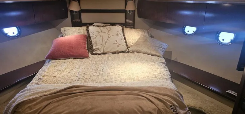 Slide: The Image of Luxurious bedroom interior of 2011 Cruisers Yachts 540 with cozy bedding and ambient lighting. - 15