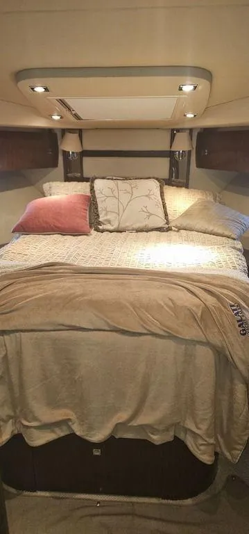 Slide: The Image of Luxurious bedroom interior of 2011 Cruisers Yachts 540 with elegant bedding and ambient lighting. - 19