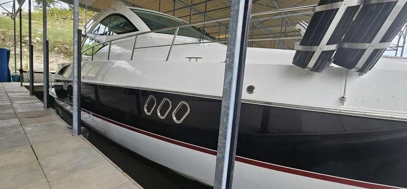 Slide: The Image of 2011 Cruisers Yachts 540 docked under a covered marina. - 2