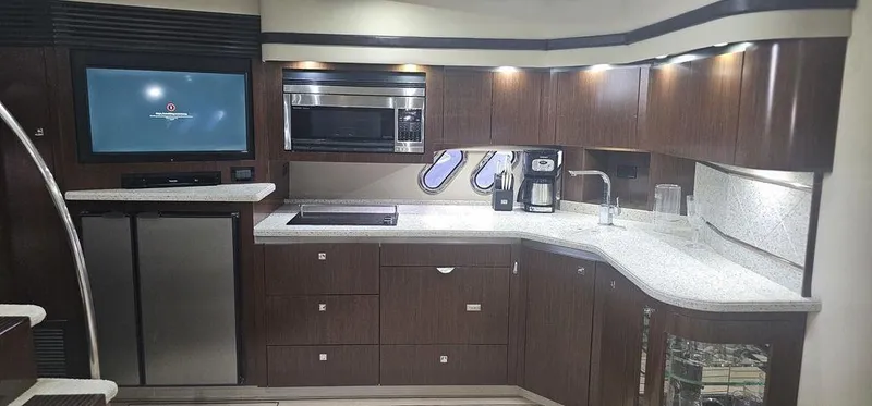 Slide: The Image of Luxurious kitchen interior of 2011 Cruisers Yachts 540 with modern appliances and sleek cabinetry. - 23