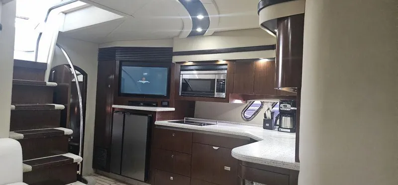 Slide: The Image of Luxurious interior of 2011 Cruisers Yachts 540, featuring modern kitchen and entertainment area. - 24