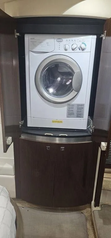Slide: The Image of Washing machine inside 2011 Cruisers Yachts 540, wooden cabinet enclosure. - 28