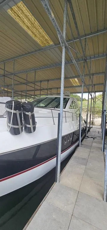 Slide: The Image of 2011 Cruisers Yachts 540 docked under a covered marina. - 4