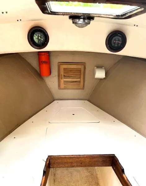 Slide: The Image of 1984 SISU Cuddy boat interior with compass, gauges, and storage. - 2