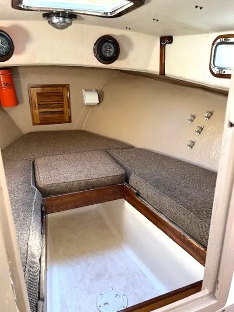 Slide: The Image of 1984 SISU Cuddy cabin interior with cushioned seating and storage space. - 7