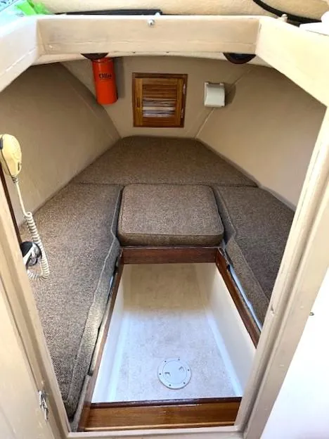 Slide: The Image of 1984 SISU Cuddy cabin interior with beige cushions and wooden accents. - 8