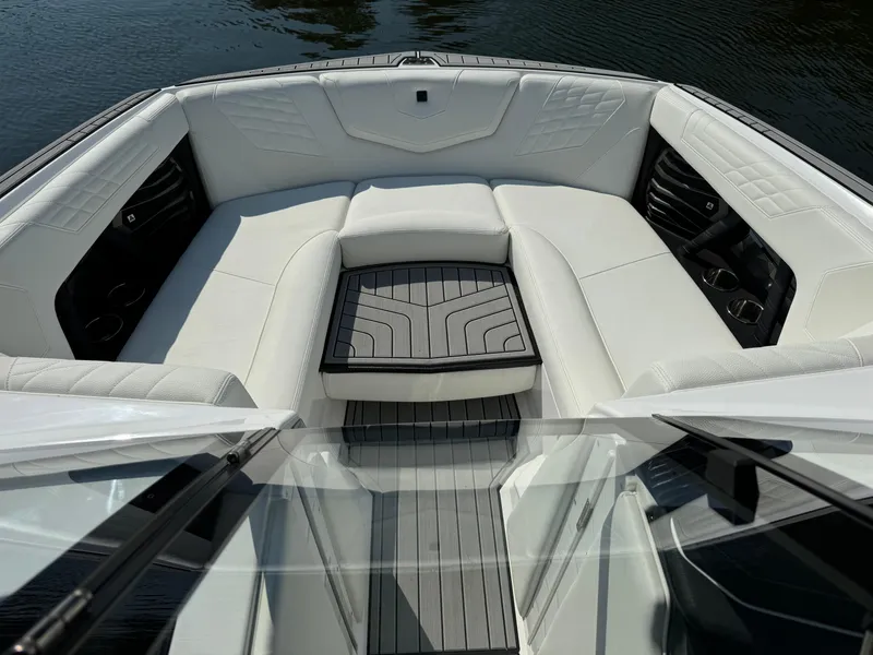 Slide: The Image of 2024 Nautique G23 Coastal Edition boat with luxurious white seating and sleek design. - 10