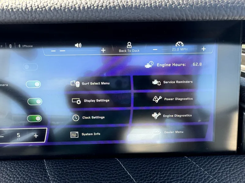 Slide: The Image of 2024 Nautique G23 Coastal Edition touchscreen displaying engine hours and settings menu. - 13