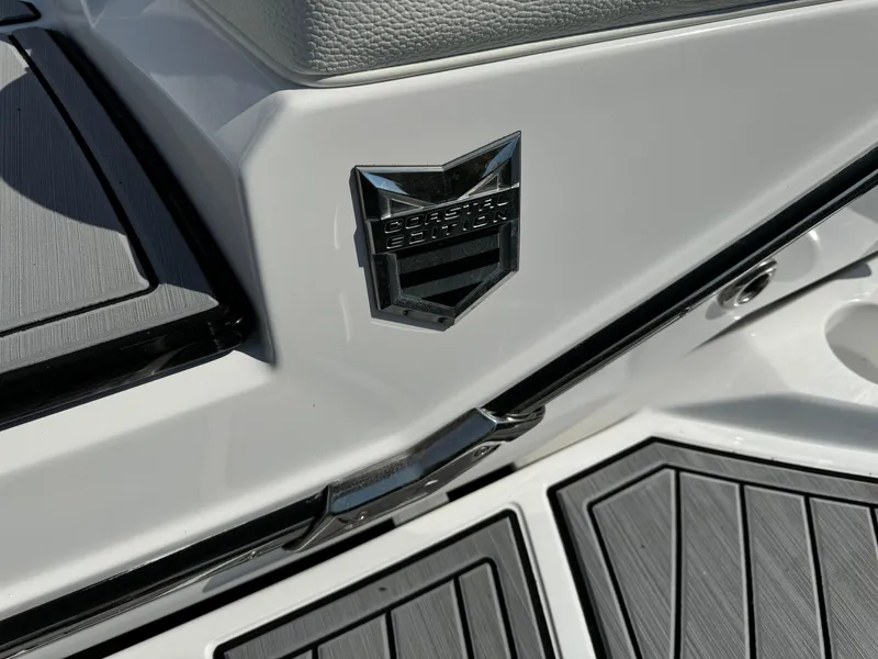 Slide: The Image of 2024 Nautique G23 Coastal Edition boat detail with sleek design and emblem. - 14
