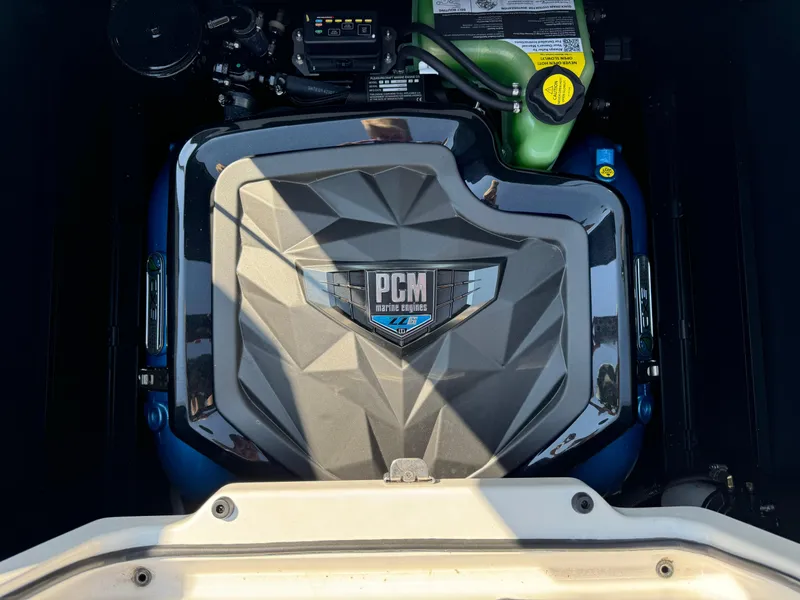 Slide: The Image of 2024 Nautique G23 Coastal Edition engine, PCM cover visible. - 15