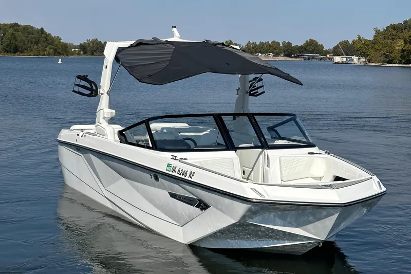 Slide: The Image of 2024 Nautique G23 Coastal Edition boat on a serene lake. - 5