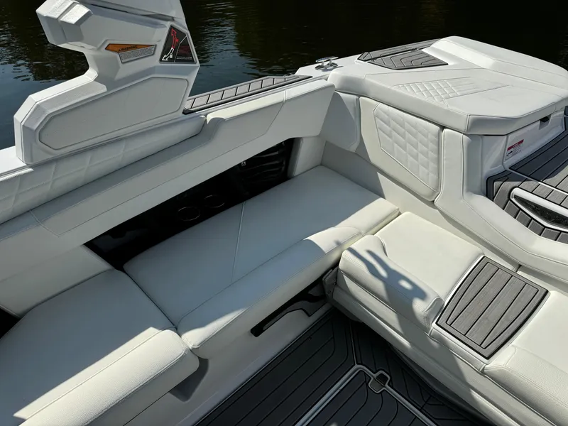 Slide: The Image of 2024 Nautique G23 Coastal Edition interior with sleek white seating and modern design. - 8