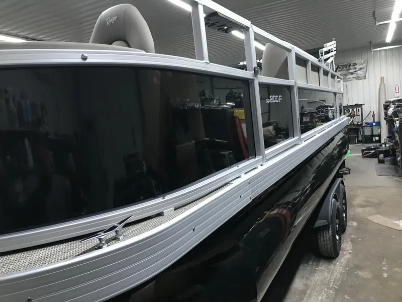Slide: The Image of 2025 Ranger Reata 200F boat in a garage, showcasing sleek design and modern features. - 10