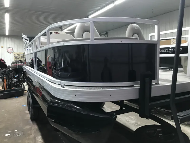 Slide: The Image of 2025 Ranger Reata 200F boat in a garage, surrounded by tools and equipment. - 13