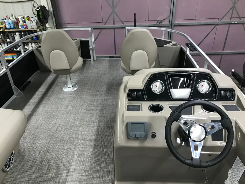 Slide: The Image of 2025 Ranger Reata 200F boat interior with seating and console. - 23