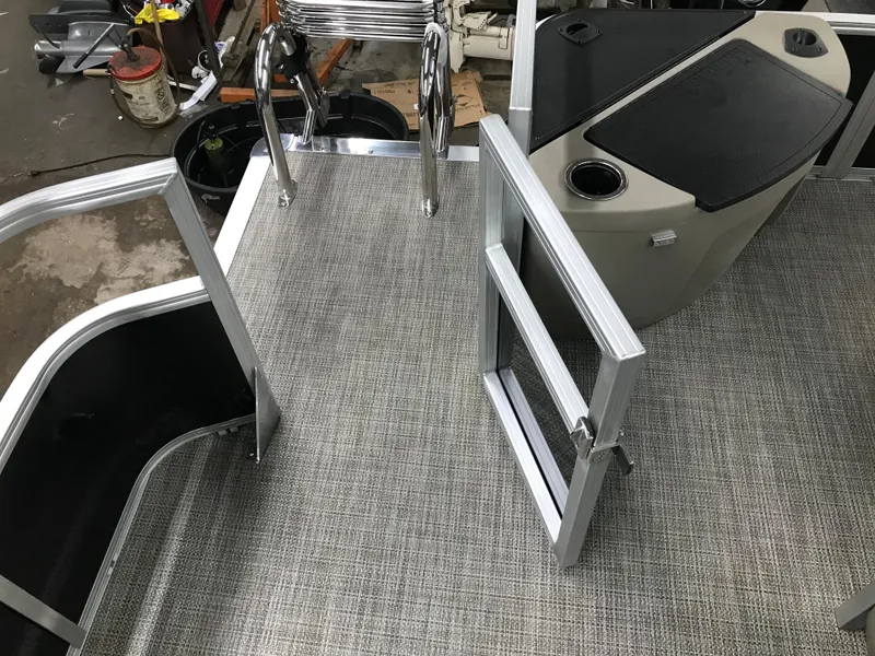 Slide: The Image of 2025 Ranger Reata 200F boat interior with beige seating and carpeted flooring. - 26