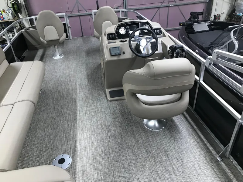 Slide: The Image of 2025 Ranger Reata 200F boat interior with beige seating and modern dashboard. - 31