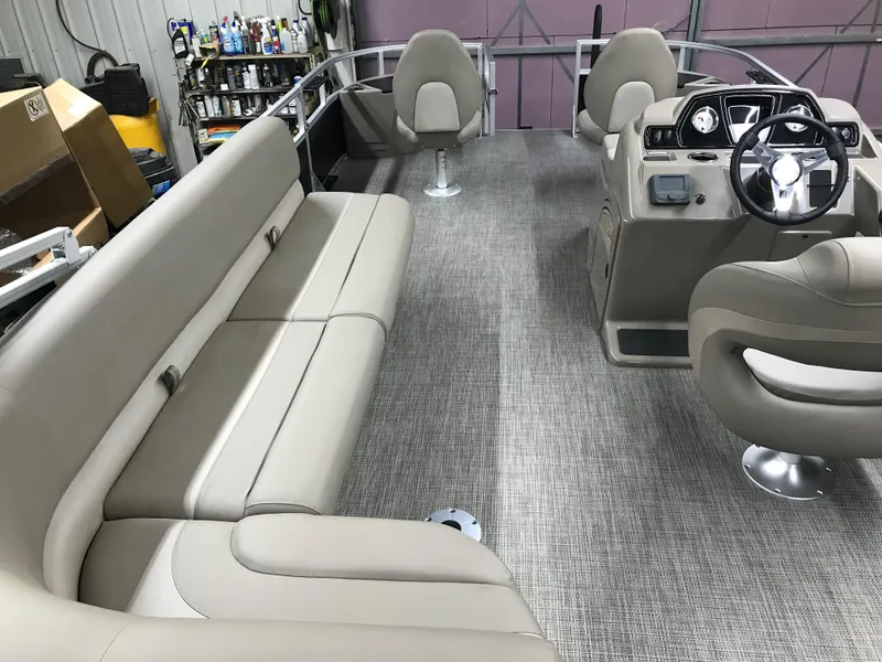 Slide: The Image of 2025 Ranger Reata 200F boat interior with beige seating and steering console. - 32