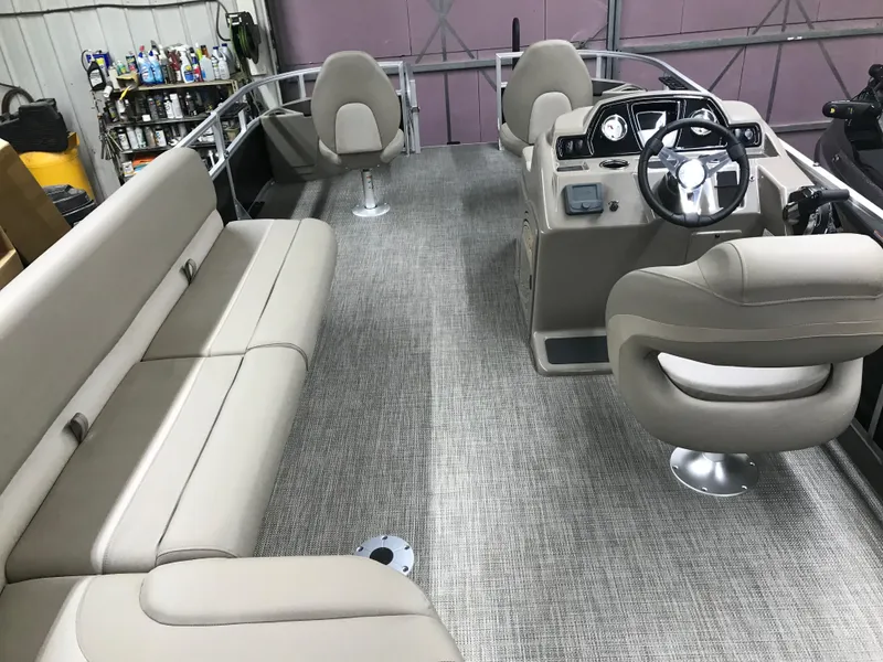 Slide: The Image of 2025 Ranger Reata 200F boat with Mercury engine, covered and stored indoors. - 33