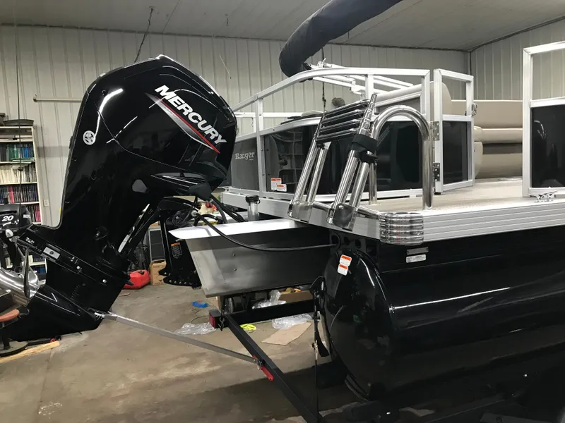 Slide: The Image of 2025 Ranger Reata 200F pontoon boat in a showroom setting. - 5