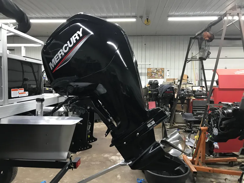 Slide: The Image of 2025 Ranger Reata 200F boat in a workshop, featuring a powerful outboard motor. - 7