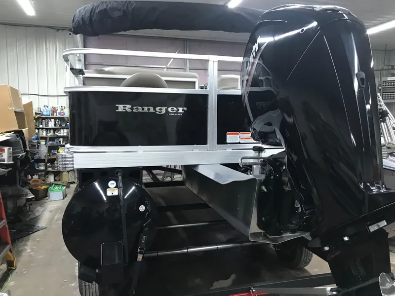 Slide: The Image of 2025 Ranger Reata 200F boat, rear view in indoor showroom. - 8