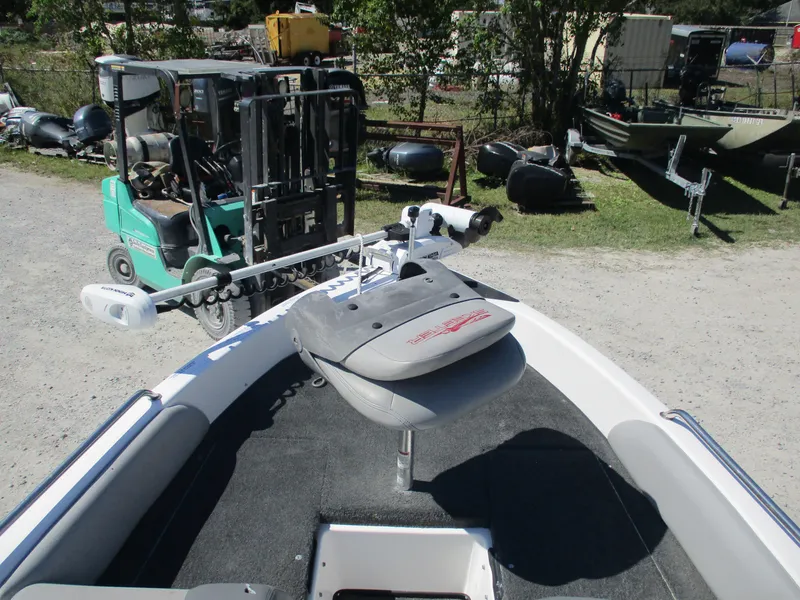 Slide: The Image of 2008 Skeeter 190 SKI FISH SL190 boat with trolling motor and seat, parked near forklift. - 8