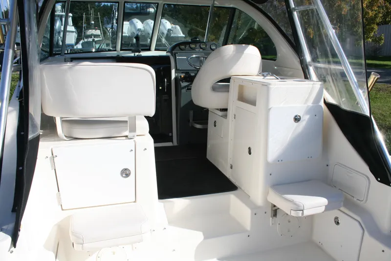 Slide: The Image of 2005 Pursuit 3370 Offshore boat interior with seating and helm. - 2