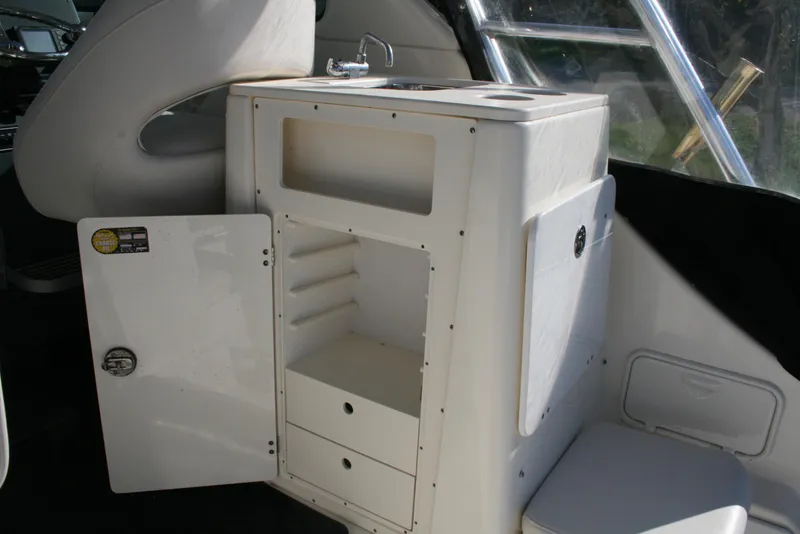 Slide: The Image of 2005 Pursuit 3370 Offshore boat interior with storage cabinet and sink. - 4