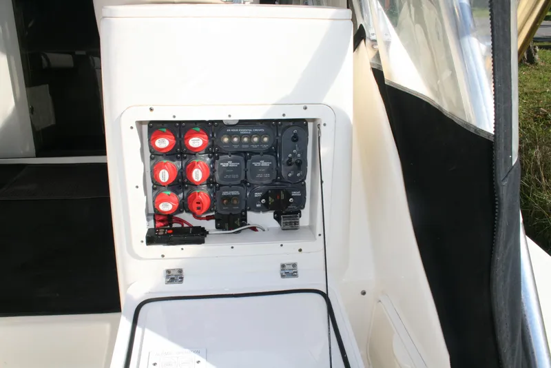 Slide: The Image of Electrical panel of 2005 Pursuit 3370 Offshore boat, featuring battery switches and controls. - 5