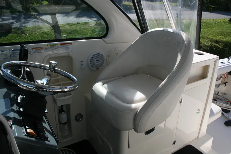 Slide: The Image of 2005 Pursuit 3370 Offshore boat interior with steering wheel and captain's chair. - 8