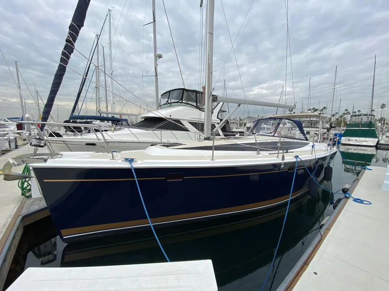 Slide: The Image of 2014 Marlow-Hunter 40 sailboat docked at marina under cloudy sky. - 12