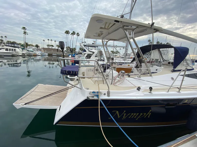 Slide: The Image of 2014 Marlow Hunter 40 sailboat docked in a marina, featuring sleek design and spacious deck. - 18