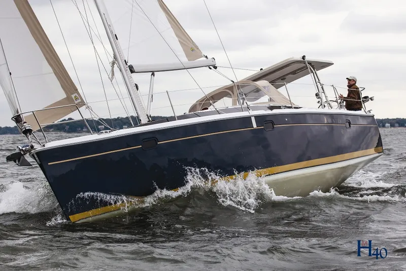 Slide: The Image of 2014 Marlow-Hunter 40 sailboat navigating choppy waters, showcasing sleek design and performance. - 2