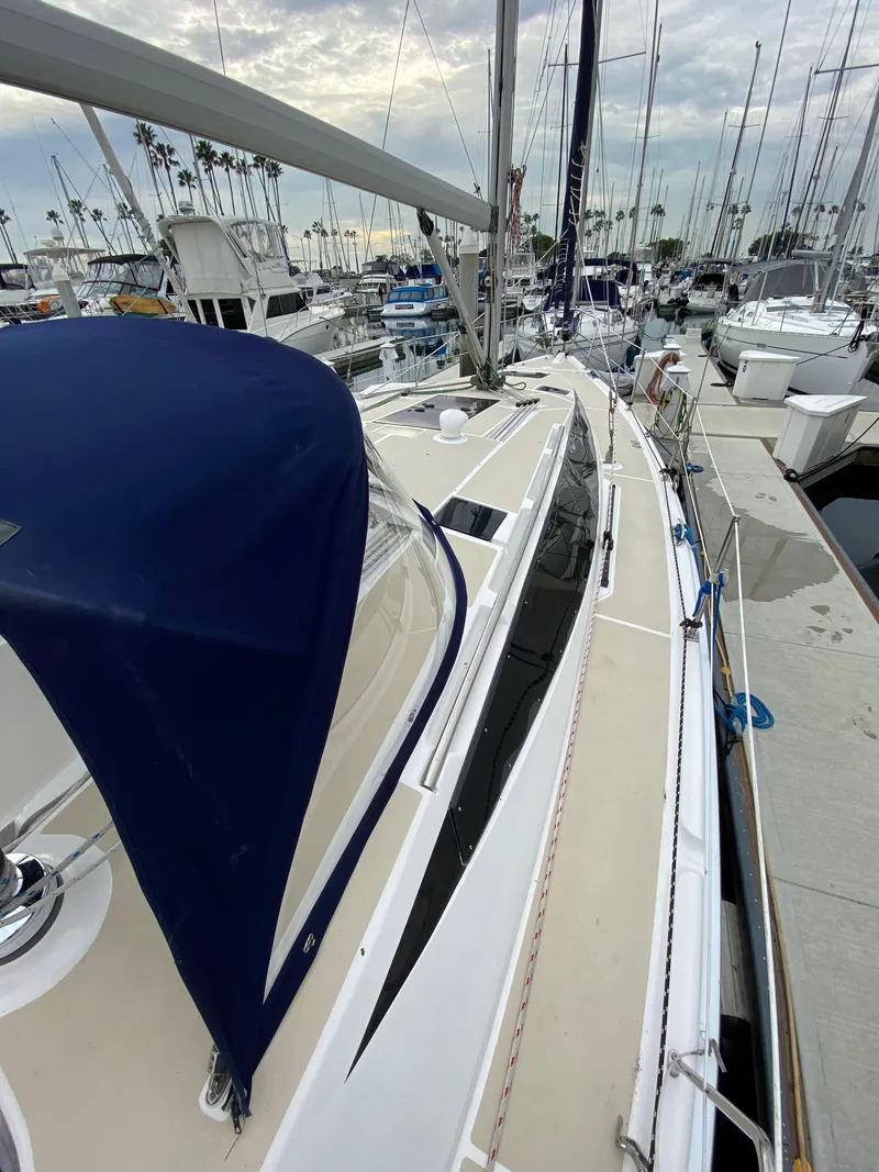 Slide: The Image of 2014 Marlow-Hunter 40 sailboat docked in marina, featuring sleek design and blue canopy. - 20