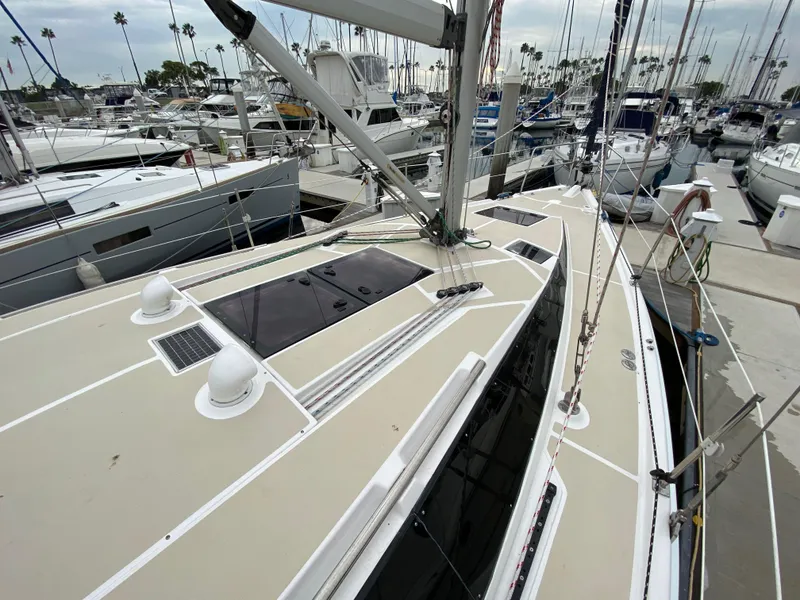 Slide: The Image of 2014 Marlow Hunter 40 sailboat docked in marina, surrounded by other boats. - 21
