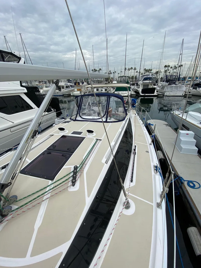 Slide: The Image of 2014 Marlow Hunter 40 sailboat docked in marina, overcast sky, surrounded by other boats. - 26