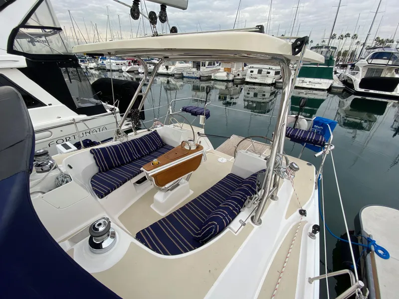 Slide: The Image of 2014 Marlow Hunter 40 sailboat with striped seating in a marina. - 28